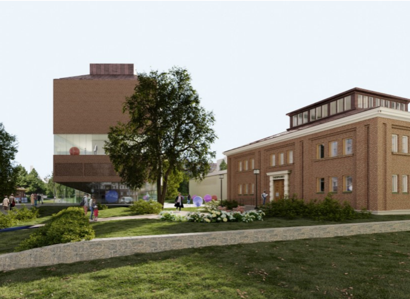 Two red brick buildings, new and old.
